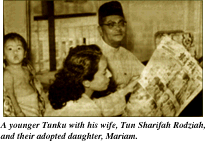 A younger Tunku with his wife, Tun Sharifah Rodziah, and their adopted daughter, Mariam.