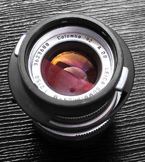 Leica Summicron-M 1:2/50mm Special Colombo '92 collectible edition with engraved lens data and lens hood inversly stored