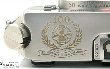 The emblem of 100 years Schmidt Group of Companies on a LEICA M6 Platinum