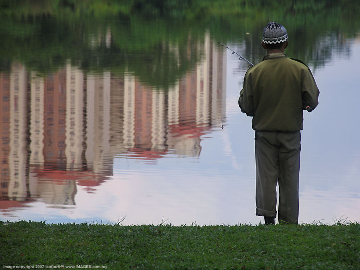 Fishing by the pond near residential area at a lazy afternoon., Kuala lumpur.