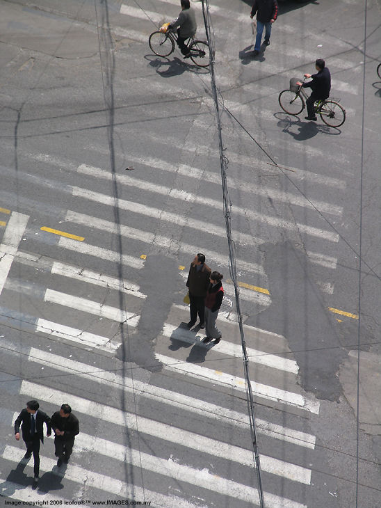 men in the wire.. a traffic cross junction, Shanghai, China