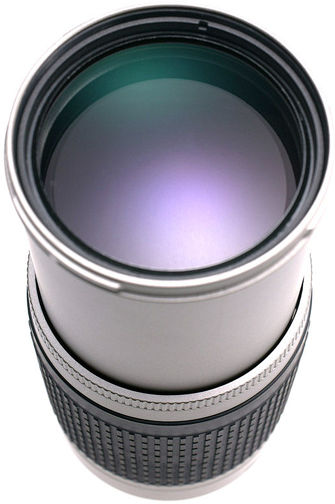Front lens element of AF Nikkor zoom 70-300mm G silver finishing on lens extension