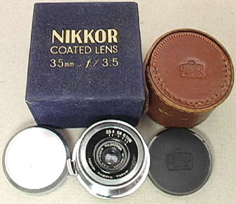 A typical setup of an old Nikkor coated lens 3.5cm wideangle with blue box, leatehr case and metal hood