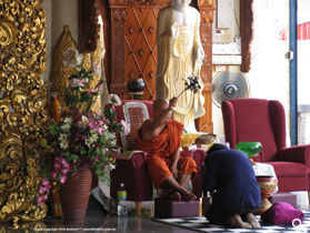 Monks at Dhammikarama Burmese Temple, Penang Island offers prayers to visitors