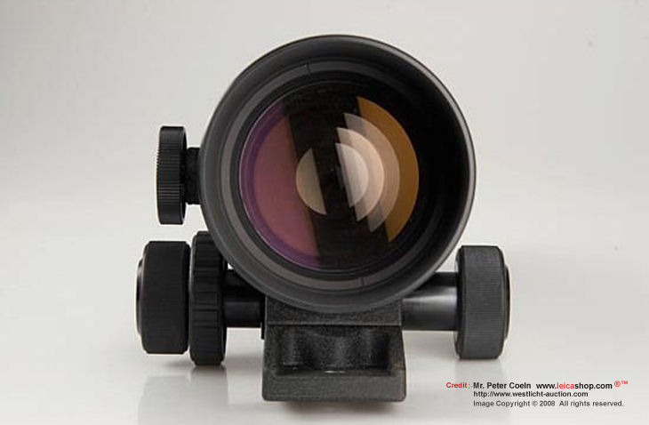 Canon super telephoto lens FL mount 400mm f/5.6 front view with reflective front lens element coating and focusing unit ad the base